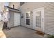 Back patio featuring a door, gray siding and concrete floor at 9562 Littleleaf Dr, Charlotte, NC 28215