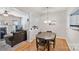 Bright dining area with hardwood floors adjacent to a comfortable living space at 10094 Treeside Ln, Matthews, NC 28105