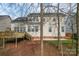 Backyard view of the home featuring a large deck, patio, and well-maintained lawn at 1017 Anduin Falls Dr, Charlotte, NC 28269