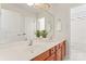 Bathroom with double sink vanity and well-lit mirror at 1017 Anduin Falls Dr, Charlotte, NC 28269