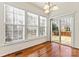 Bright breakfast nook featuring hardwood floors, large windows, and sliding door access to the deck at 1017 Anduin Falls Dr, Charlotte, NC 28269