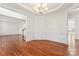 Dining room with hardwood floors, elegant trim details, and modern lighting at 1017 Anduin Falls Dr, Charlotte, NC 28269