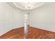 Dining room with hardwood floors, elegant trim details, and modern lighting at 1017 Anduin Falls Dr, Charlotte, NC 28269