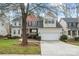 Charming two-story home with a two-car garage, manicured lawn, and mature trees at 1017 Anduin Falls Dr, Charlotte, NC 28269