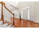 Welcoming foyer with hardwood floors, staircase, and a view into other living spaces at 1017 Anduin Falls Dr, Charlotte, NC 28269