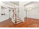 Spacious foyer with hardwood floors, staircase, and elegant trim details at 1017 Anduin Falls Dr, Charlotte, NC 28269