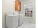 Laundry room featuring a washer, dryer and upper cabinets at 1017 Anduin Falls Dr, Charlotte, NC 28269