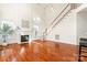 Bright living room with fireplace, staircase, and hardwood floors, creating a welcoming atmosphere at 1017 Anduin Falls Dr, Charlotte, NC 28269