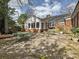 A brick house with a spacious patio area perfect for outdoor entertaining and relaxation at 1030 Bolling Rd, Charlotte, NC 28207