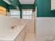 Bathroom featuring white tile, a glass enclosed shower, vanity, and large mirror at 1030 Bolling Rd, Charlotte, NC 28207