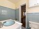 Retro bathroom featuring blue tiled walls, and a blue sink basin at 1030 Bolling Rd, Charlotte, NC 28207