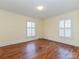 Bedroom with hardwood floors and two windows at 1030 Bolling Rd, Charlotte, NC 28207