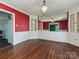 Dining room with hardwood floors, built-in cabinets, and chandelier lighting at 1030 Bolling Rd, Charlotte, NC 28207