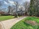 A cozy home with manicured lawn and a long driveway at 1030 Bolling Rd, Charlotte, NC 28207