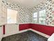 A small, cozy dining area with a half-door, natural light, and a floral-themed wallpaper at 1030 Bolling Rd, Charlotte, NC 28207