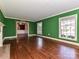 Spacious living room featuring hardwood floors, natural light, and detailed trim at 1030 Bolling Rd, Charlotte, NC 28207