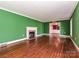 Bright living room with hardwood floors, fireplace and decorative trim at 1030 Bolling Rd, Charlotte, NC 28207