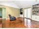 A cozy living room with hardwood floors, a bookshelf, and French doors at 1030 Bolling Rd, Charlotte, NC 28207