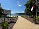 Scenic beach with informational signage and clear waters, inviting residents for a relaxing day at 104 Trestle Cir, New London, NC 28127