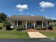 Inviting clubhouse exterior featuring a covered entrance, well-maintained landscaping, and a brick walkway at 104 Trestle Cir, New London, NC 28127