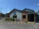 Commercial building featuring blue siding, brick accents, and ample parking spaces in a lakeside community at 104 Trestle Cir, New London, NC 28127