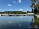 Picturesque view of a well-maintained boat dock on a tranquil lake at 104 Trestle Cir, New London, NC 28127