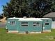 Inviting mobile home exterior featuring a manicured lawn and peaceful surroundings at 104 Trestle Cir, New London, NC 28127