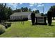 Exterior view of Bodin Shores Chapel with a manicured lawn and signage at 104 Trestle Cir, New London, NC 28127