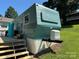 Exterior of a blue and white mobile home with a small deck and stairs at 104 Trestle Cir, New London, NC 28127