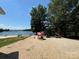 Charming lakeside playground with mushroom decor and a beach in the distance at 104 Trestle Cir, New London, NC 28127