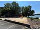 Playground near parking area and lake featuring a colorful slide and climbing area at 104 Trestle Cir, New London, NC 28127