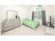 Bright bedroom with a green zig-zag bedspread and gray dresser at 10836 Clark St, Davidson, NC 28036