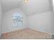 Empty bedroom with ample natural light from a large, arched window at 10836 Clark St, Davidson, NC 28036