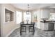 Bright dining area with modern light fixture, breakfast bar, and door to outdoor patio at 10836 Clark St, Davidson, NC 28036