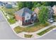 Two-story home features a brick facade, manicured lawn, and inviting front porch at 10836 Clark St, Davidson, NC 28036