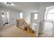 Bright foyer with carpeted stairs, wrought iron railings, and views of the entrance below at 10836 Clark St, Davidson, NC 28036