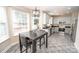 Open kitchen and dining area filled with natural light, stainless steel appliances and granite countertops at 10836 Clark St, Davidson, NC 28036