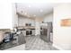 Well-lit kitchen featuring granite countertops, stainless steel appliances, and neutral-toned cabinets at 10836 Clark St, Davidson, NC 28036