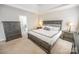 Inviting main bedroom featuring a king bed, neutral decor, and ensuite bathroom access at 10836 Clark St, Davidson, NC 28036