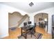 Open-concept home office adjacent to a staircase and dining area, featuring hardwood floors at 10836 Clark St, Davidson, NC 28036