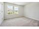 Carpeted bedroom illuminated by two bright windows with exterior views at 109 Alluvium Ln, Waxhaw, NC 28173