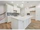 Modern kitchen with large island, quartz countertops, stainless steel appliances, and stylish backsplash at 109 Alluvium Ln, Waxhaw, NC 28173