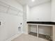 Well-lit laundry room featuring a built-in counter and ample storage space at 109 Alluvium Ln, Waxhaw, NC 28173