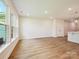 Spacious living room with wood-look flooring, recessed lighting, and a view into the kitchen area at 109 Alluvium Ln, Waxhaw, NC 28173