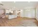 Open-concept kitchen and living area with modern pendant lighting, stainless appliances, and ample counter space at 109 Alluvium Ln, Waxhaw, NC 28173