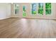 Bright living area featuring wood-look floors, large windows, and a glass door at 109 Alluvium Ln, Waxhaw, NC 28173