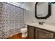 Bathroom features a modern vanity and shower with decorative curtain at 11000 White Stag Dr, Charlotte, NC 28269