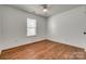 Neutral bedroom with hardwood flooring, window, and ceiling fan at 11000 White Stag Dr, Charlotte, NC 28269