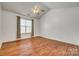Bright bedroom with hardwood floors, ceiling fan, and large window for lots of natural light at 11000 White Stag Dr, Charlotte, NC 28269