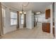 Bright dining area featuring tile floors, a modern chandelier, and natural light, perfect for Gathering meals at 11000 White Stag Dr, Charlotte, NC 28269